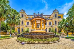 The yellow front of An Dinh Palace with Trung Lap Pavilion