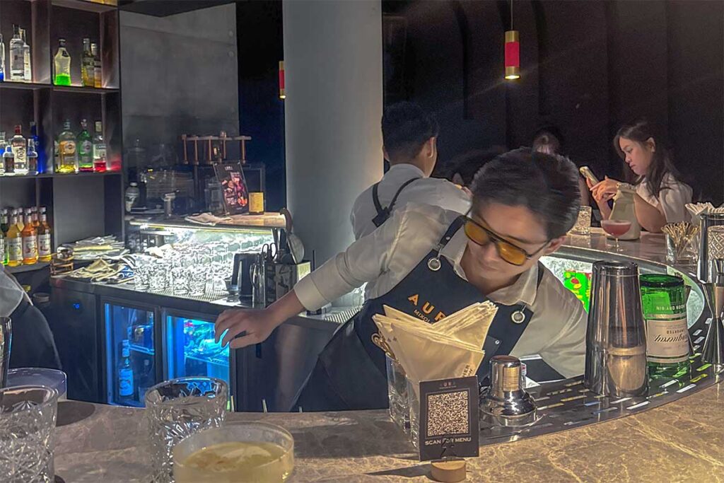 A cocktail waiter at AURA – Mixology & Karaoke in Hue