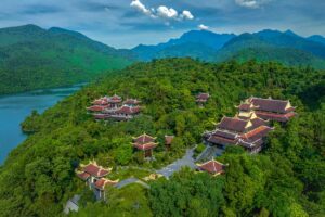 The Bach Ma Zen Monastery seen from the air, hidden between trees and behind a lake