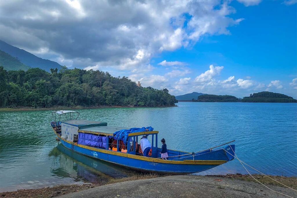 A wooden boat on a lake for bringing people to Bach Ma Zen Monastery
