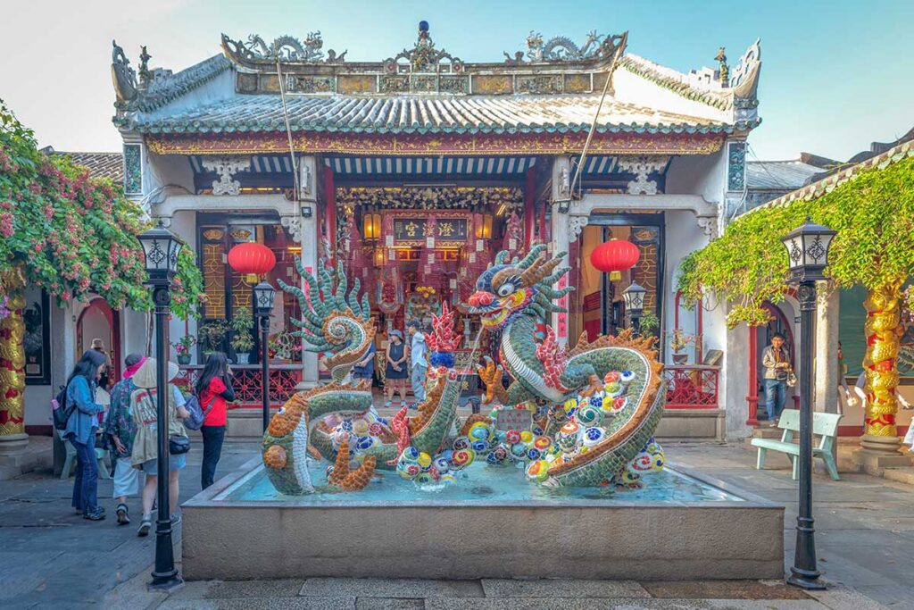 Cantonese Assembly Hall in Hoi An Ancient Town with vibrant dragon sculptures, red lanterns, and traditional Chinese architectural details.