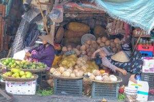 Local shopkeepers are sleeping in their stall full of coconuts at Dong Ba Market in Hue