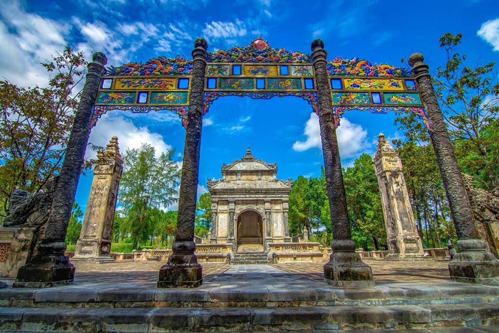 Three entrance gate with behind a tomb building at Dong Khanh Tomb in Hue