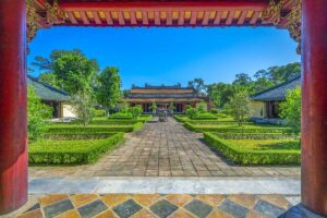 One of the main temple buildings and open courtyard with garden inside Gia Long Tomb