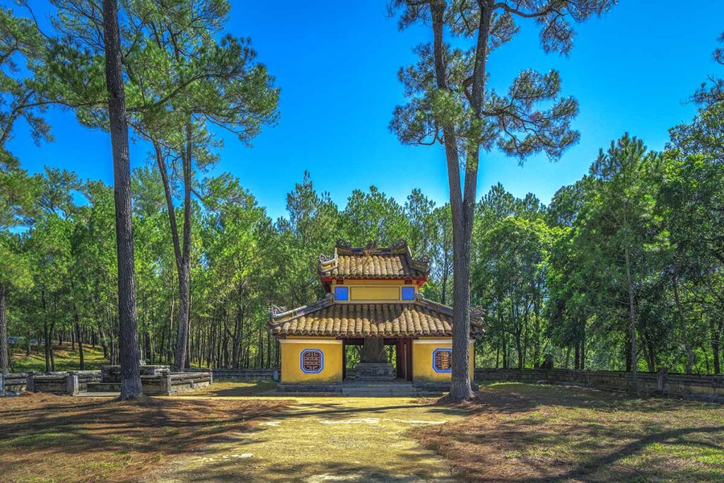The Stele Pavilion (Bi Đình) surrounded by trees part of the complex within Tomb of Gia Long