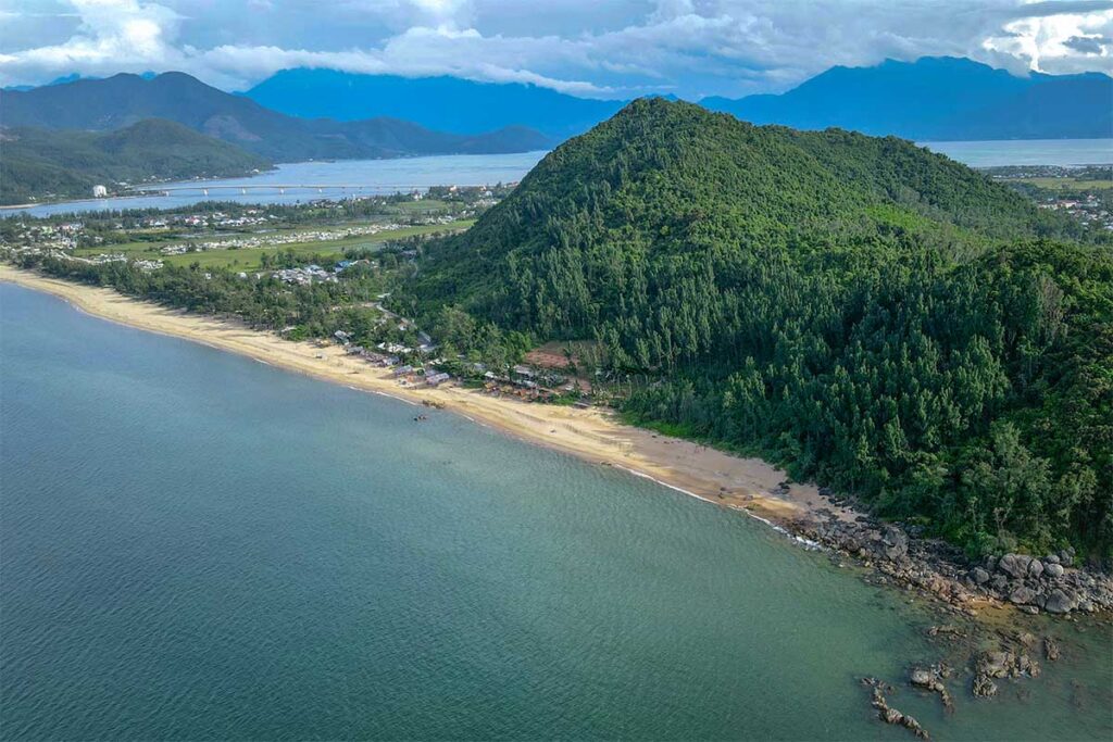 Aerial view of Ham Rong Beach with river and green mountains behind it