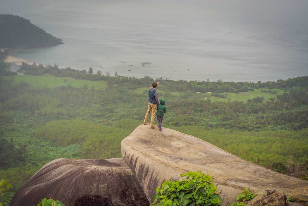 Father and child enjoying a viewpoint on a day trip from Hoi An