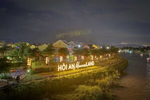 Evening scene inside Hoi An Memories Land with glowing lanterns and traditional-style buildings.