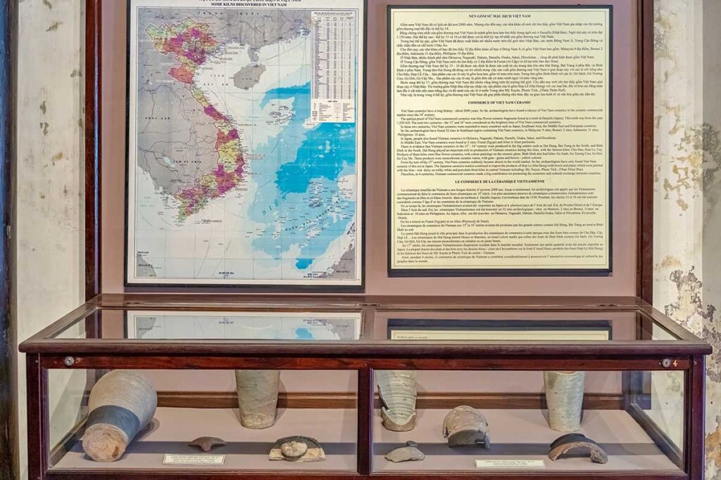 Vietnam trade ceramics exhibition with ancient pottery fragments and a map of old kiln sites across Vietnam