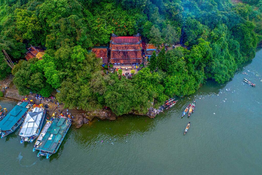 Dragon boats on the Perfume River docked at Hon Chen Temple for the local festival