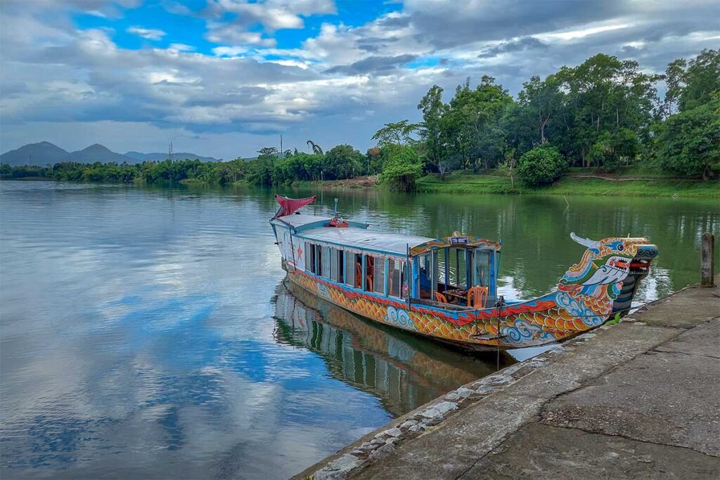 A dragon boat is docked at the Hon Chen Temple on the Perfume River