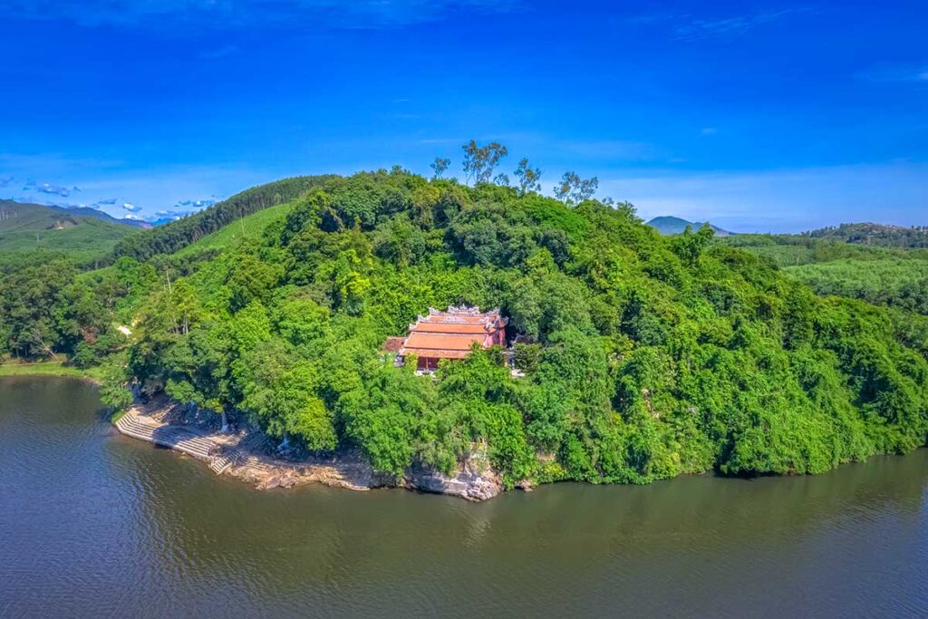 Aerial view of Hon Chen Temple in front of a river and hidden between the trees