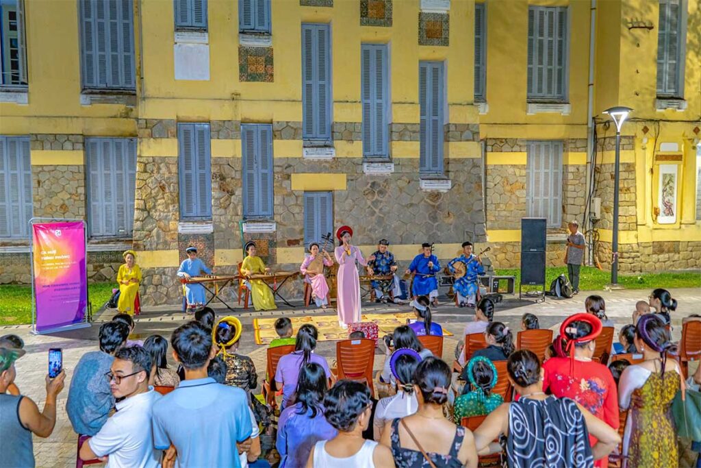 A small preformance on the street in Hue with traditional instruments and artist wearing historical clothing during Hue Festival
