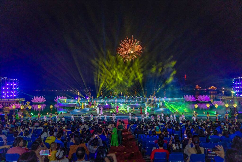 A large performance in the evening with signing and fireworks in the background during Hue Festival