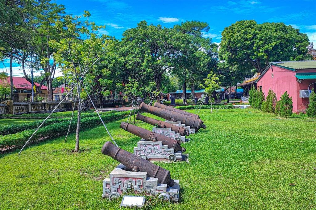 The courtyard of Hue Museum of Royal Antiques with different ancient cannons displayed in the garden area