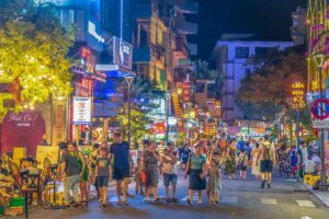Locals and foreigners walking through the streets of Hue Night Walking Street