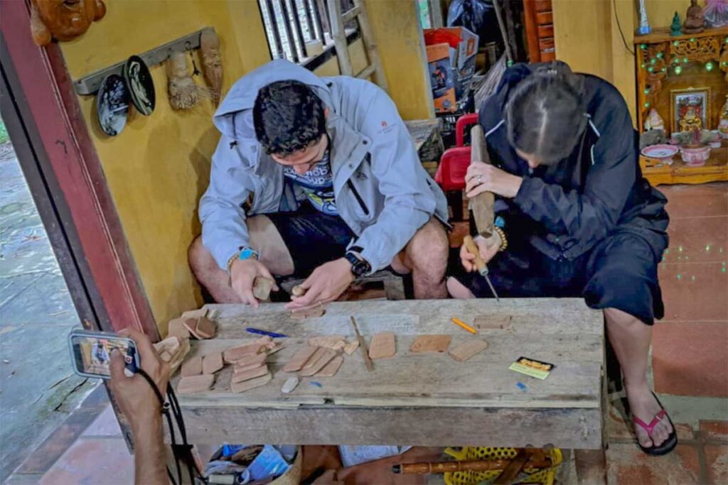 Tourists wood carving in Kim Bong Carpentry Village – Visitors learning traditional woodworking skills in Kim Bong Carpentry Village near Hoi An.