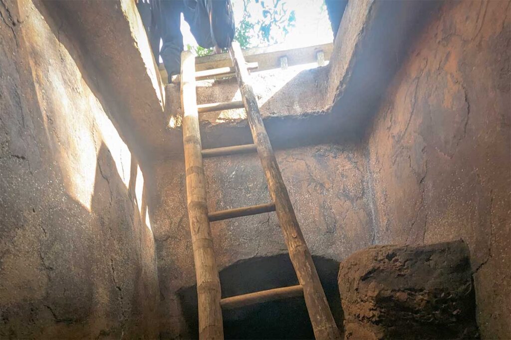 Wooden ladder leading up to a surface exit of Ky Anh Tunnels, once used as a secret escape route during wartime.