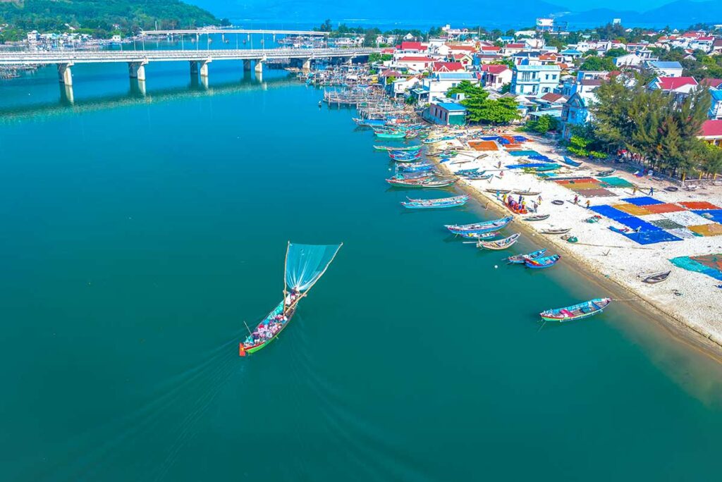 Aerial view of the beginning of Lang Co Beach with lots of fishing boats 