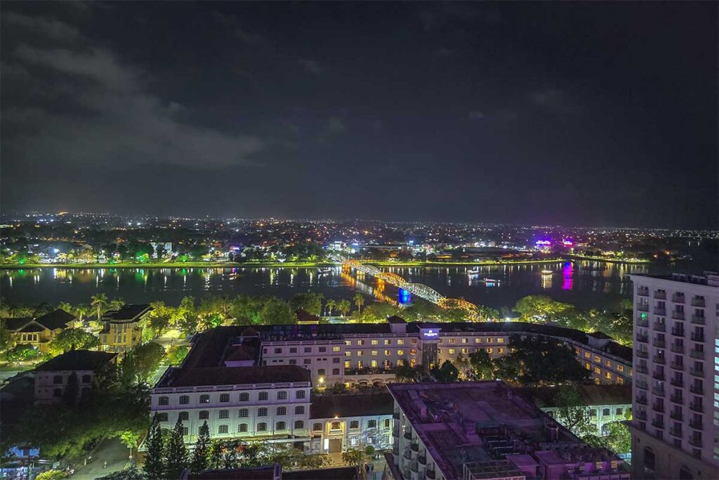 The view at night from Lotus Sky Bar in Hue over the Perfume River and Trang TIen Bridge