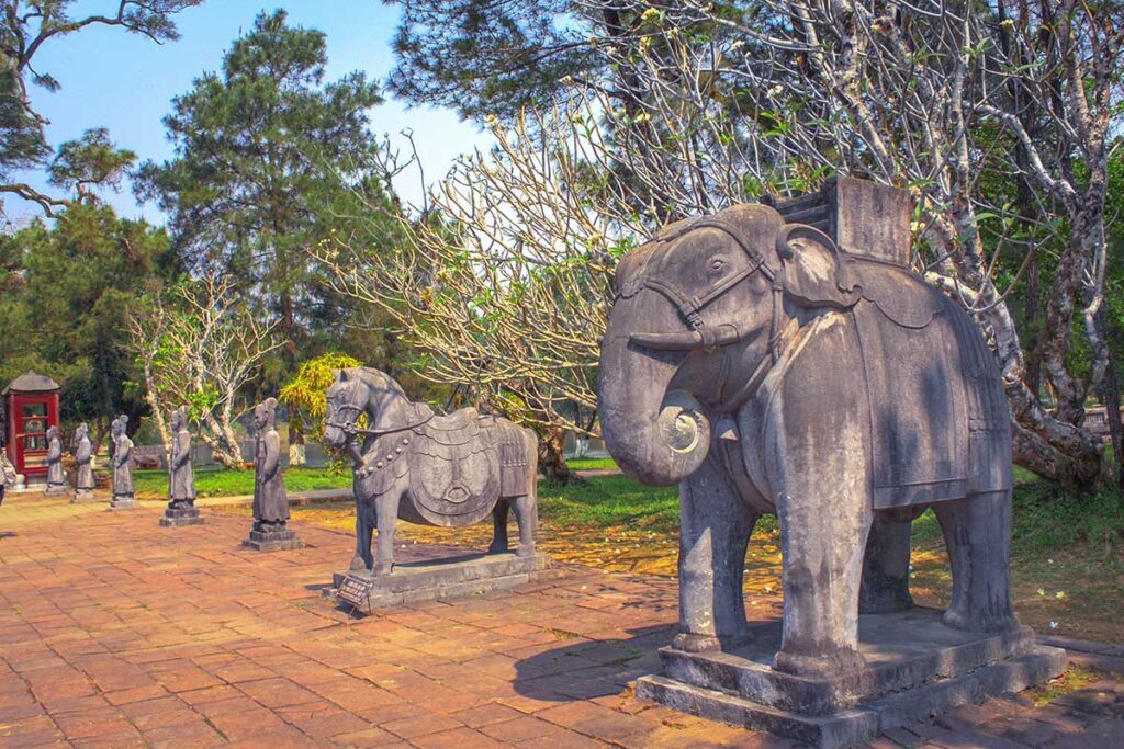 The Honour courtyard with stone statues of mandarins, elephants and horses inside the complex of Minh Mang Tomb