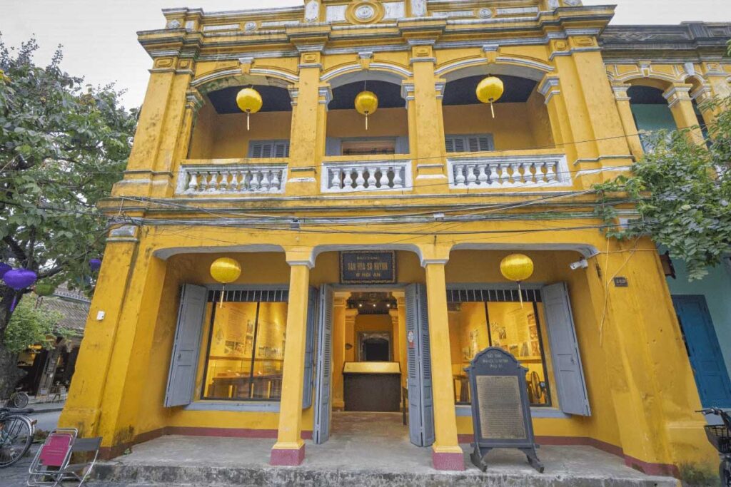 Facade of the Museum of Sa Huynh Culture in Hoi An Ancient Town – Distinctive yellow heritage building with colonial architecture and lanterns marking the entrance.