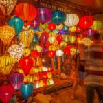 Colorful lantern shop at the night market in Hoi An Old Town, filled with traditional handmade silk lanterns glowing in warm evening light.