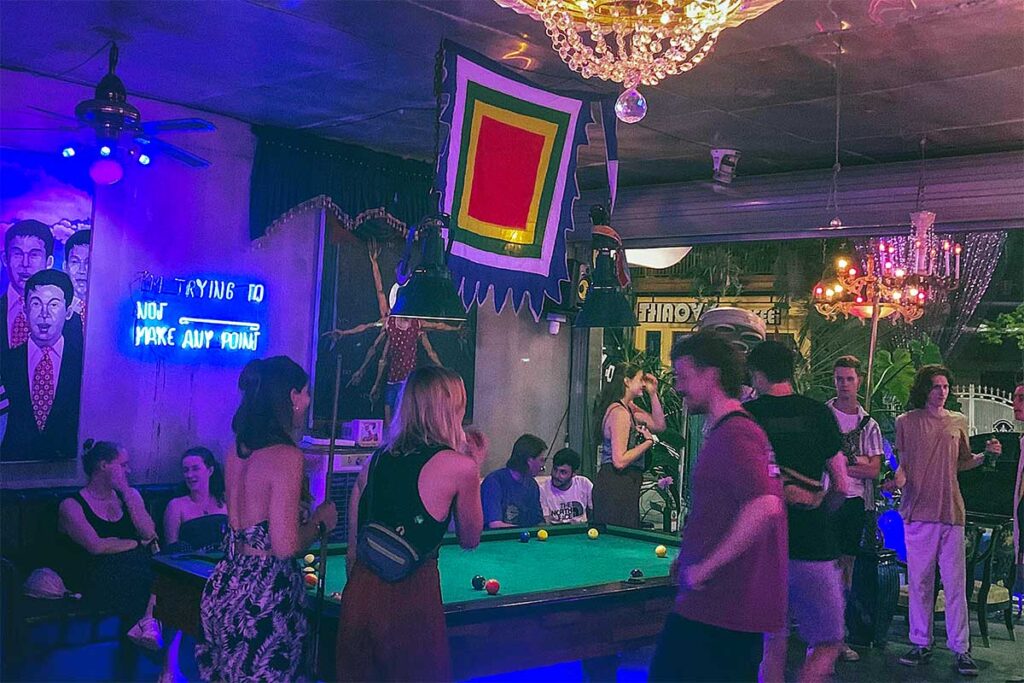 Tourists playing pool inside OCB Bar in Hue