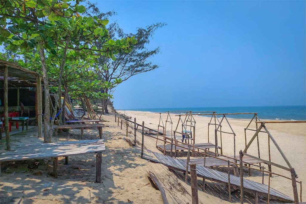 Small local restaurants and wooden sitting areas on Phu Dien Beach