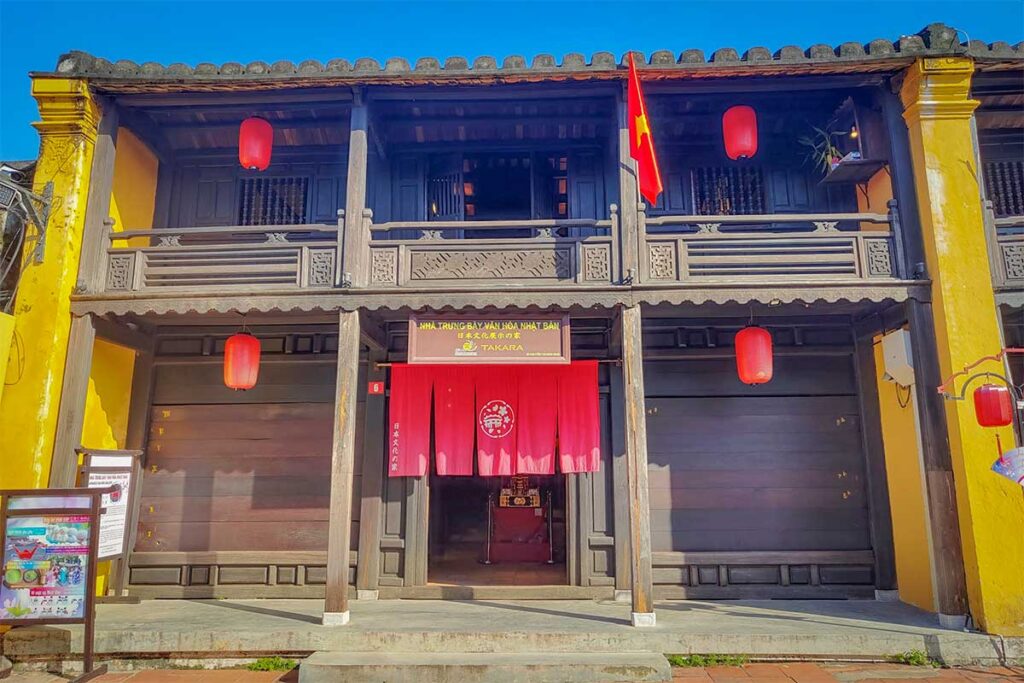 Exterior of Phung Hung Old House in Hoi An Ancient Town, a preserved wooden merchant house with yellow walls and red lanterns.
