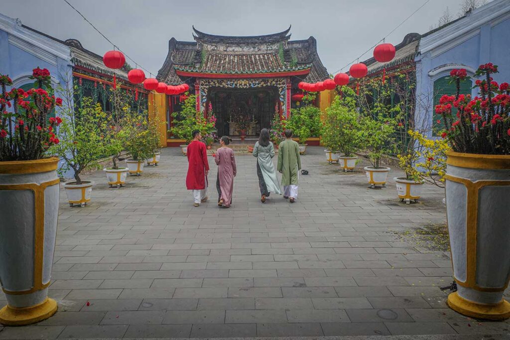 Courtyard of Quan Cong Temple Hoi An decorated with red lanterns and flowering plants