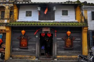 Front facade of Tan Ky Old House, decorated with red lanterns and heritage plaques marking it as a national treasure
