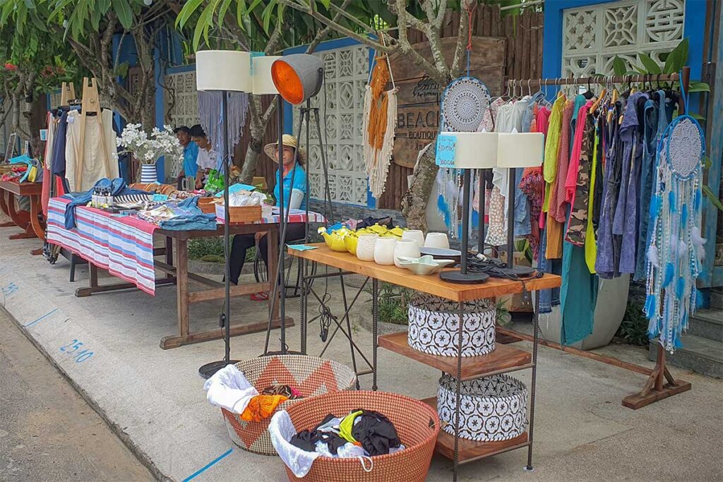 Outdoor stalls selling local clothing, crafts, and home décor at Tan Thanh Flea Market near the beach in Hoi An.