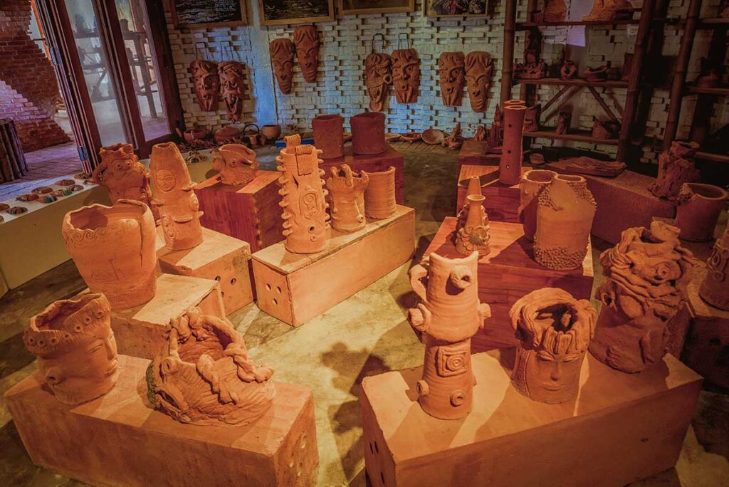 Terracotta art exhibition in Hoi An – Collection of creative clay vases, masks, and sculptures at Thanh Ha Terracotta Park’s indoor gallery.