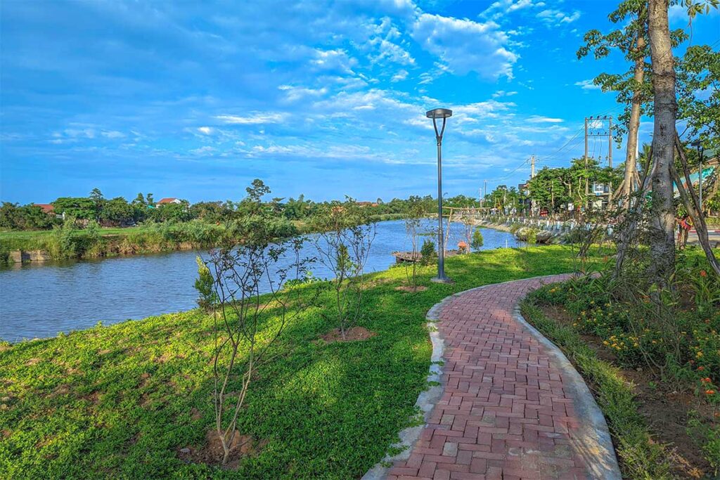 A small stone path leading along the river inside Thanh Toan Village