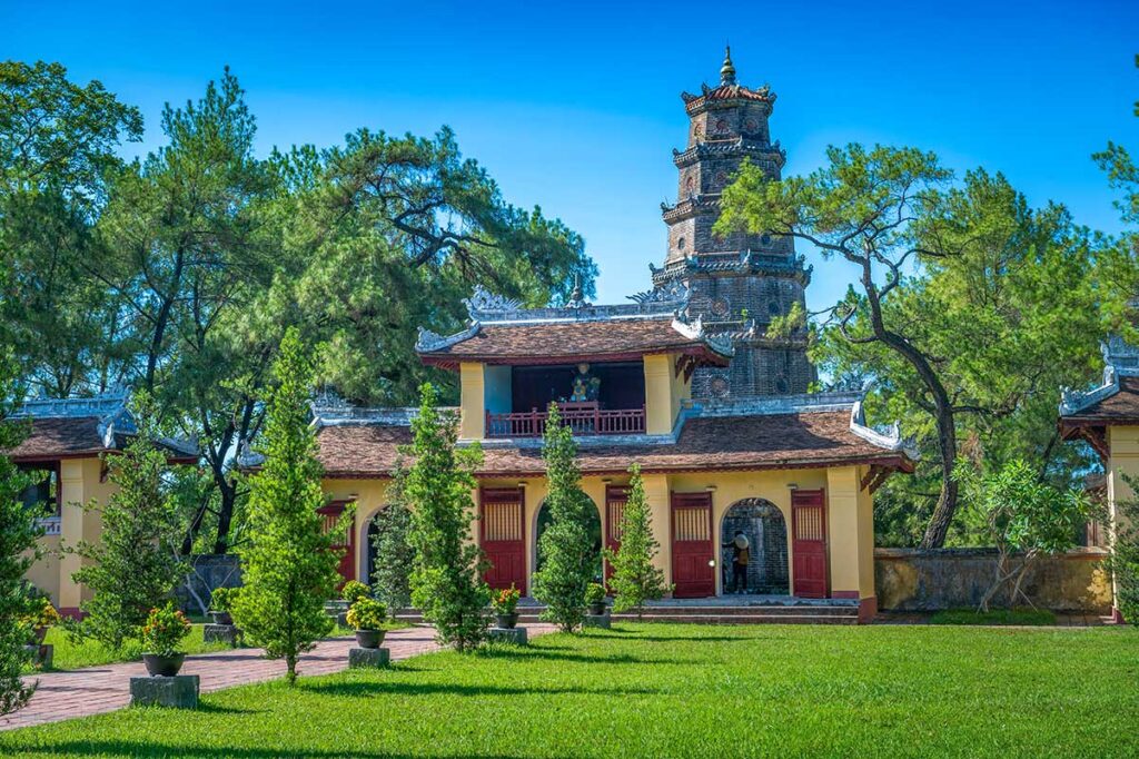 The main Tam Quan Gate surrounded by trees at Thien Mu Pagoda