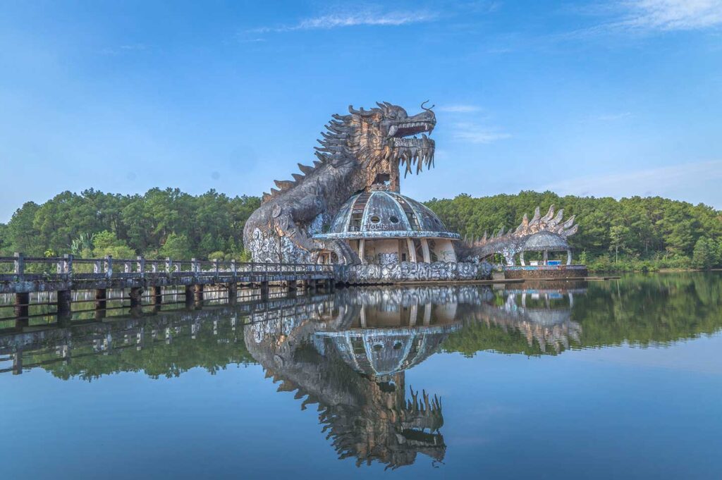 The lake with dragon shaped building inside Hue's abandoned waterpark called Thuy Tien