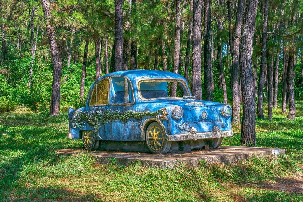 Statue of a car inside the abandoned water park in Hue