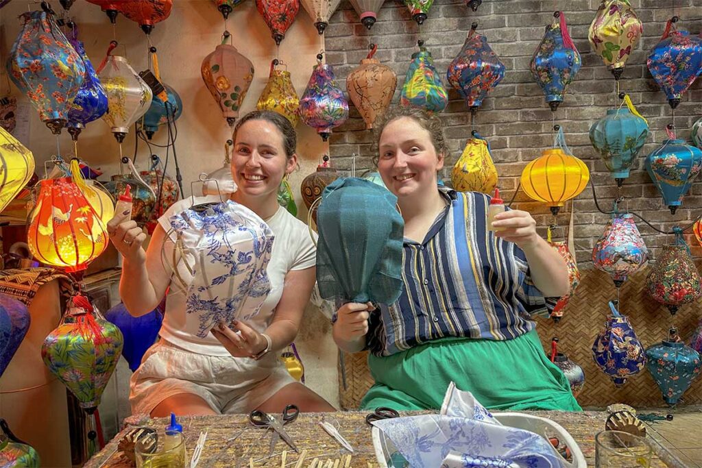 Tieng Vong Pho lantern workshop in Hoi An with travelers practicing traditional techniques.