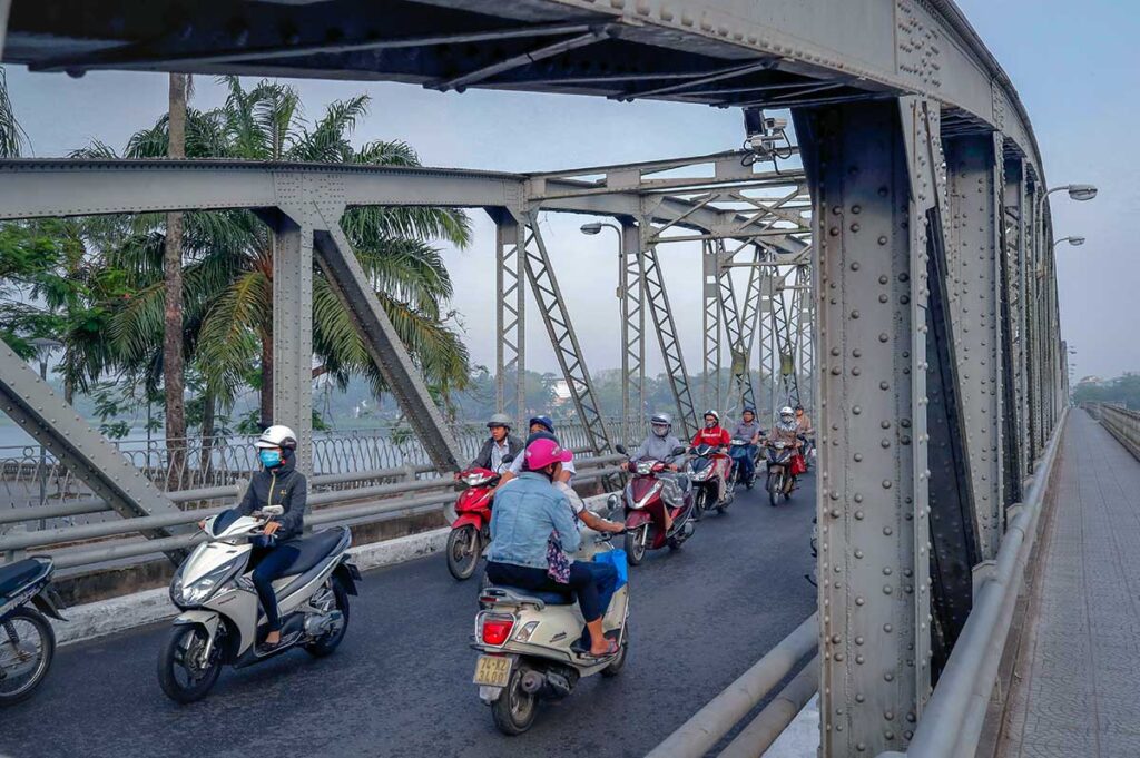 Motorbikes driving over the Trang Tien Bridge in Hue