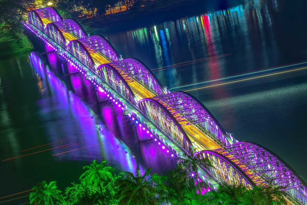 Aerial view Trang Tien Bridge seen at night with purple colors lighting up the bridge