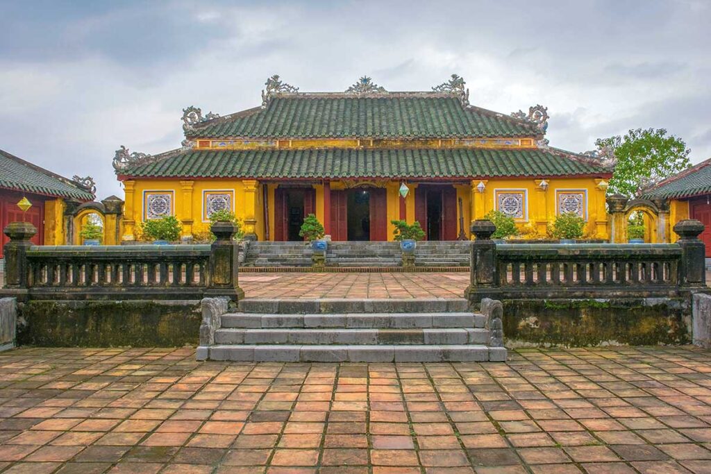 The yellow Truong Sanh Residence with traditional roof seen from the outside