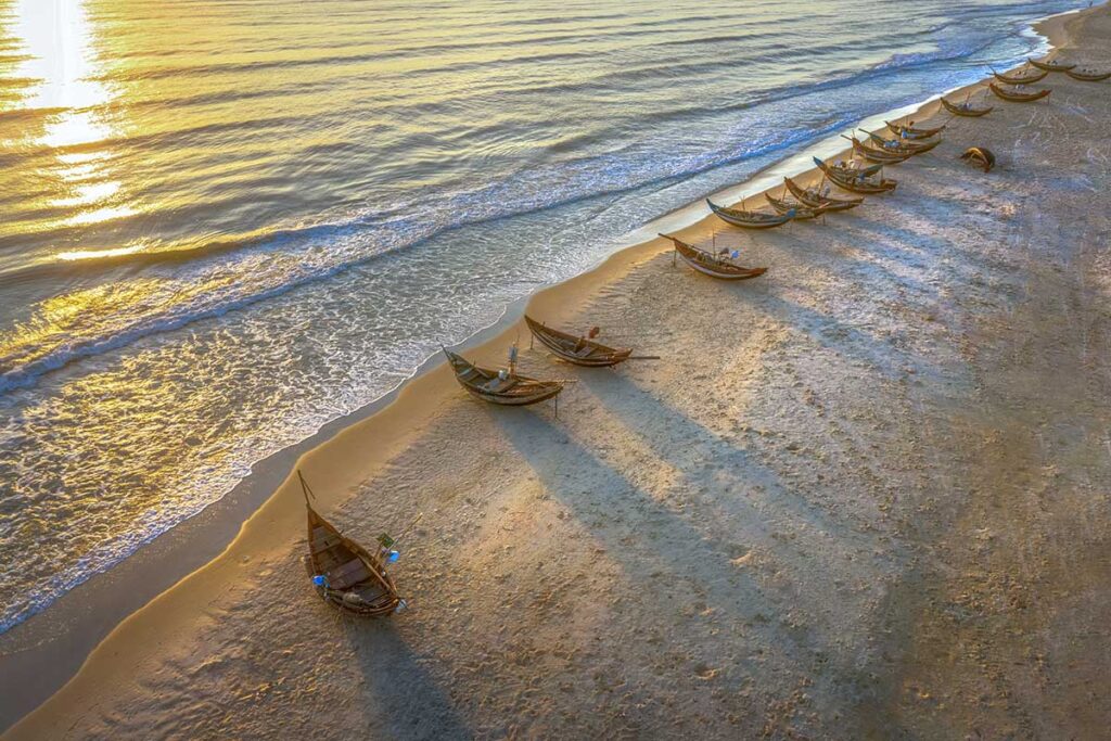 Aerial view of Vinh Thanh Beach with plenty of small wooden fishing boats