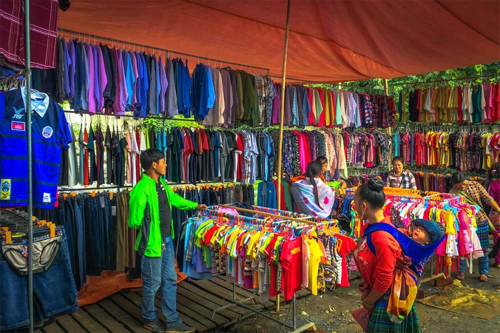 A stall with lots of clothes both modern and traditional ethnic clothes at the Cao Son Market