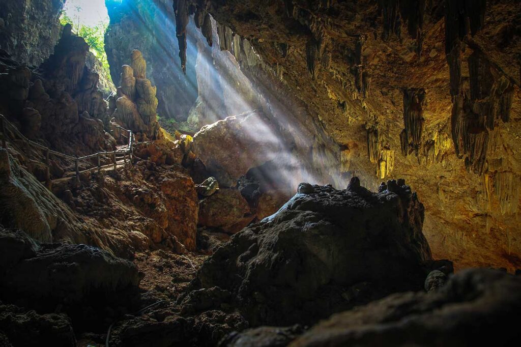Light beams coming from the caves roof opening inside Chieu Cave in Mau Chau