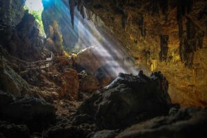 Light beams coming from the caves roof opening inside Chieu Cave in Mau Chau