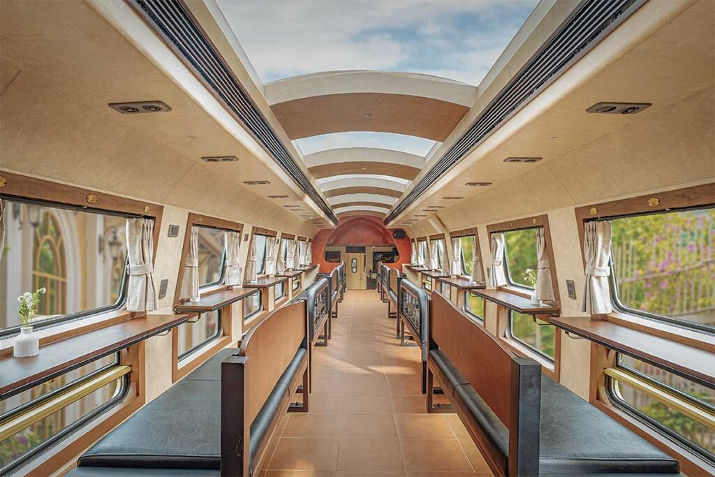 Interior of the Hanoi Five Gates double-decker train with upper-level seating and large windows designed for sightseeing in Vietnam