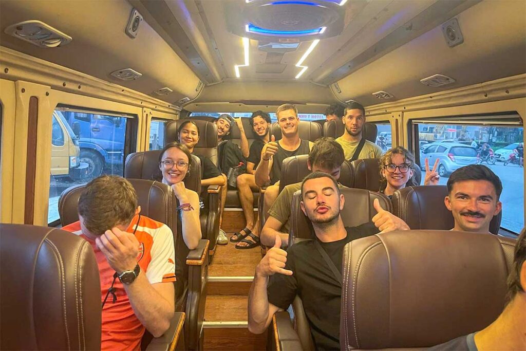 A group of backpackers sitting inside the limousine van travelling from Ha Giang to Cao Bang