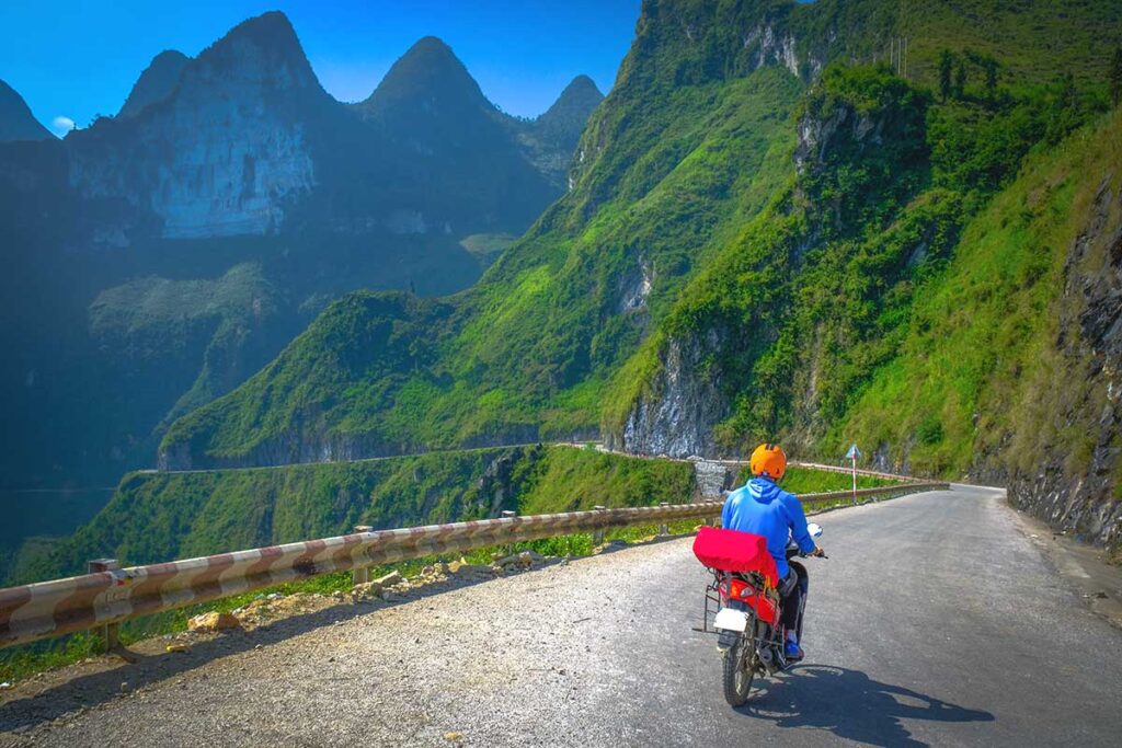 A tourist driving motorbike in Ha Giang over the Ma Pi Leng Pass