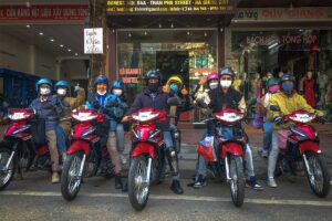 A group of friends on their motorbiked rented in Ha Giang in front of the motorbike rental shop